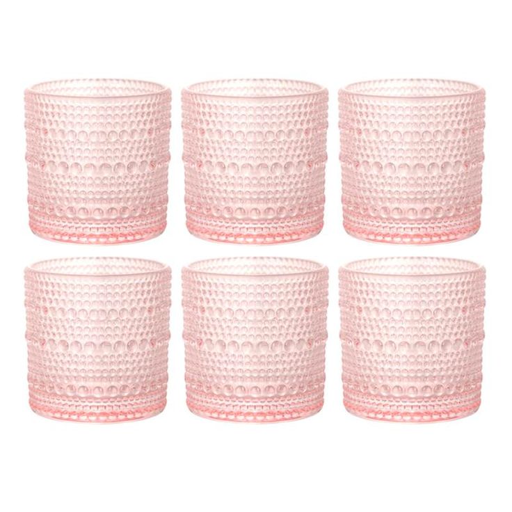 six pink glass candlesticks on a white background