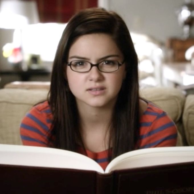 a girl with glasses is reading a book