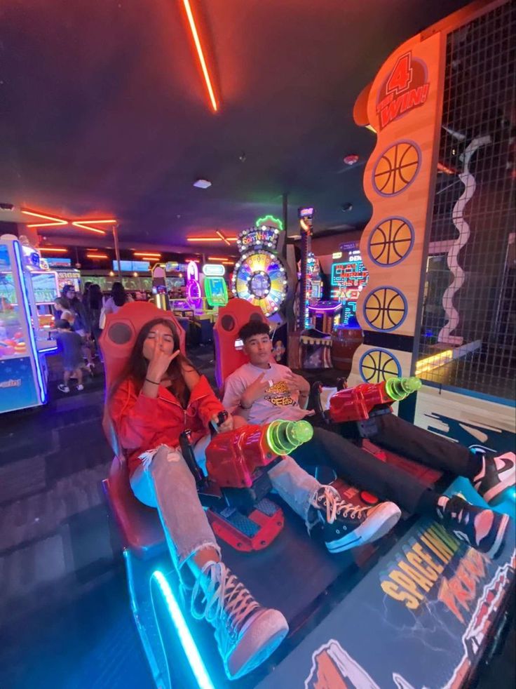 two people sitting at a table with neon lights