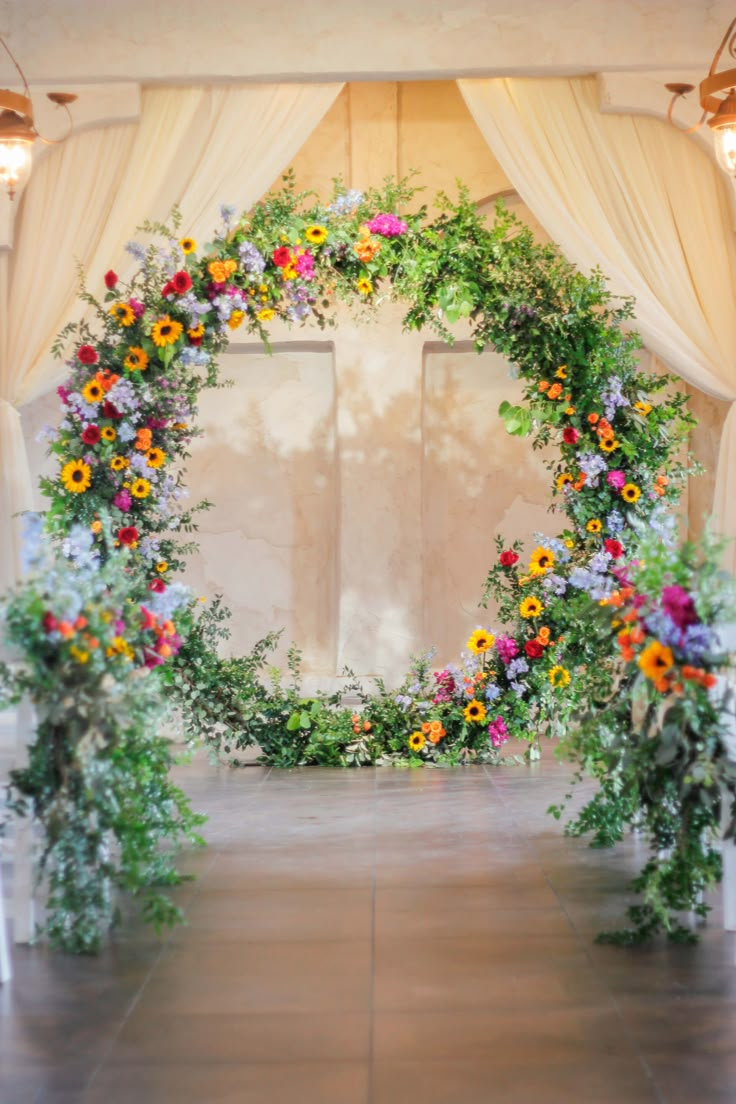 an archway decorated with flowers and greenery