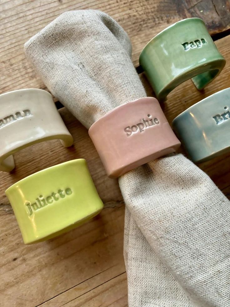 four napkin rings sitting on top of a wooden table