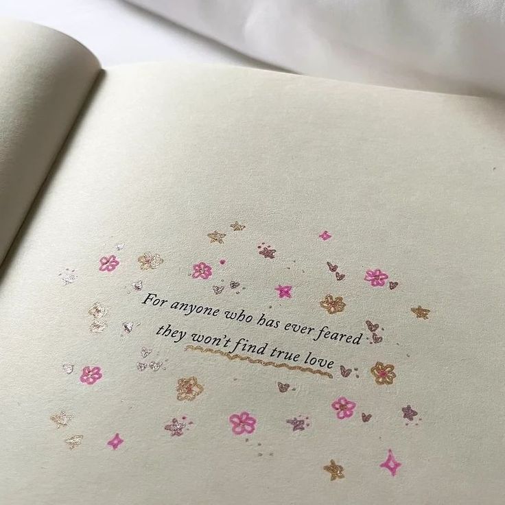 an open book with pink and gold flowers on the pages that say, for anyone who has ever found they may want to find love