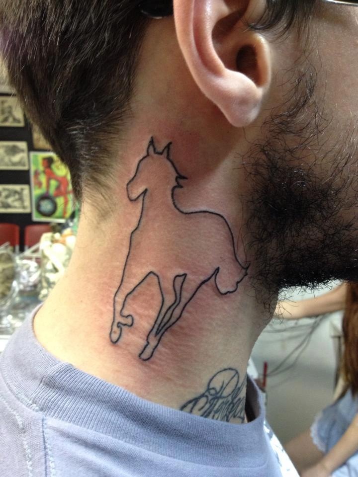 a man's neck with a horse tattoo on the back of his neck and behind his ear