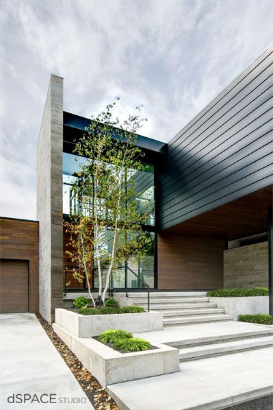 a modern house with concrete steps leading up to it