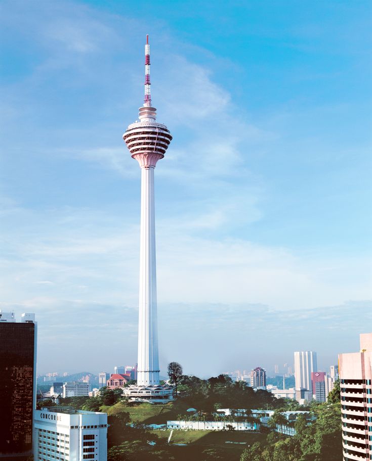 a tall white tower with a sky scraper in the middle of it's top