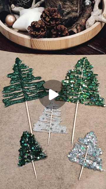 there are several christmas trees made out of glitters in a bowl on the floor