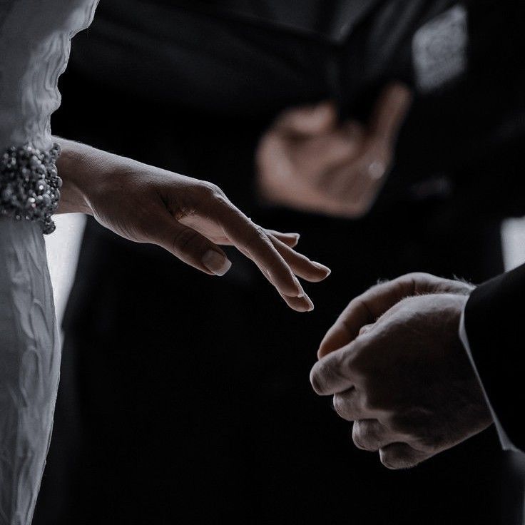 the bride and groom are touching their hands