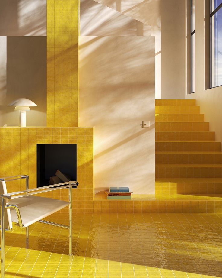 a yellow tiled room with stairs leading up to the second floor and a fire place