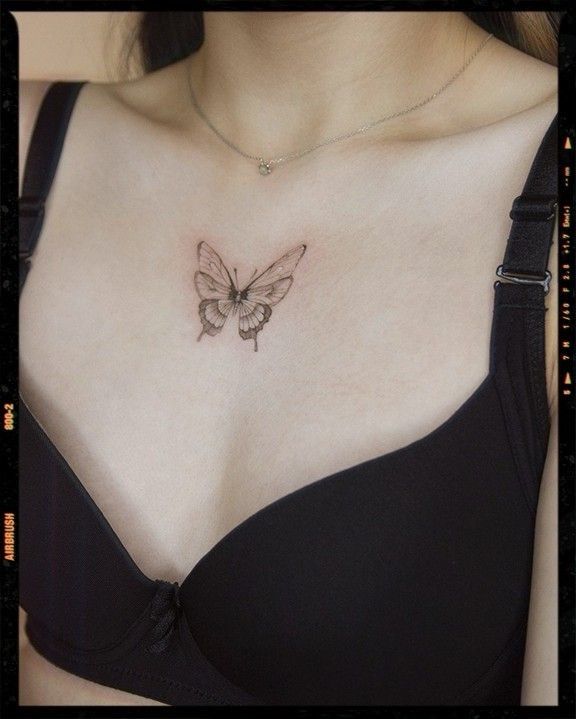 a woman with a butterfly tattoo on her chest