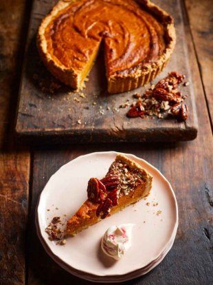 a piece of pie sitting on top of a white plate next to a slice of pie