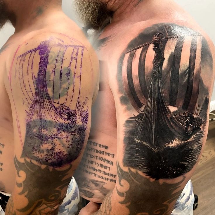 two men with tattoos on their arms and chest, one has a boat in the water