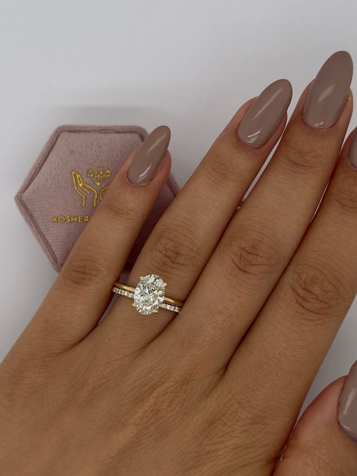 a woman's hand with a ring on it and a diamond in the middle