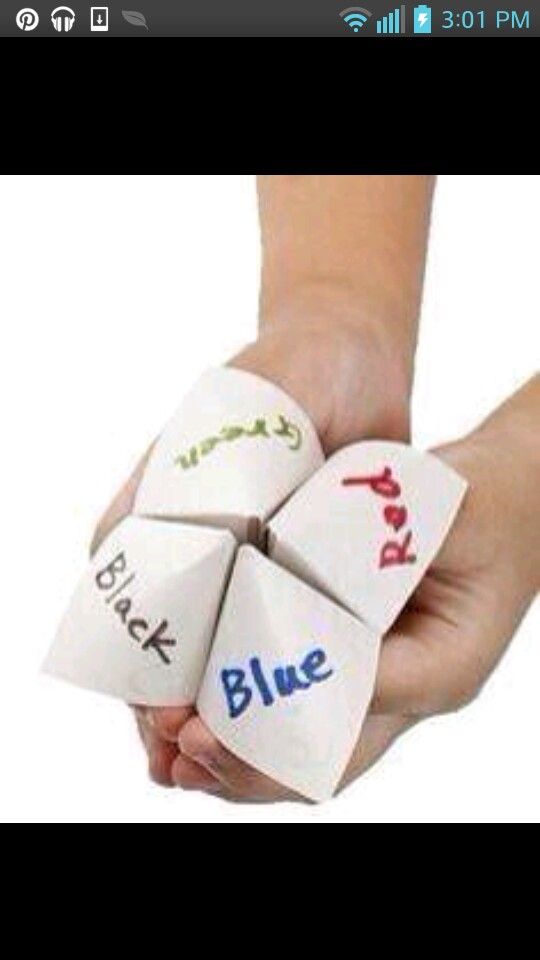 a hand holding four dices with words on them that spell out blue, red, and green