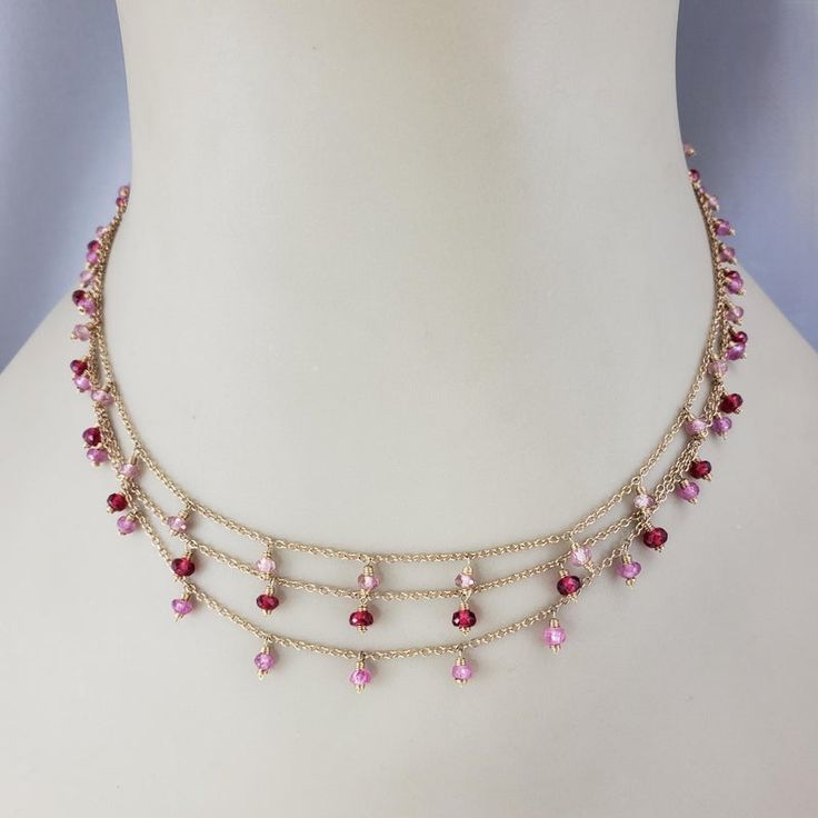 14 Karat Yellow Gold Triple Strand Gemstone Necklace-  This lovely piece features natural pink sapphires (medium pink), pink tourmaline stones (light pink) and synthetic spinel stones(dark pink) set on a 14K triple chain cable necklace.   Beads measure 6mm each.  Stamped: 14K  Size: 15 inches  Weight:  6.2 dwt. / 9.7 gr.  Very good condition, professionally polished.  Will come packaged in a gift box or pouch (when possible) and will be shipped U.S. Priority Mail Insured.  JAGI ID 1/31/24 Pink Gem Necklace, Flat Gold Necklace, Chanel Pendant, Pink Stone Necklace, Peridot Necklace, Necklace Beads, Pink Set, Tourmaline Stone, Medallion Necklace