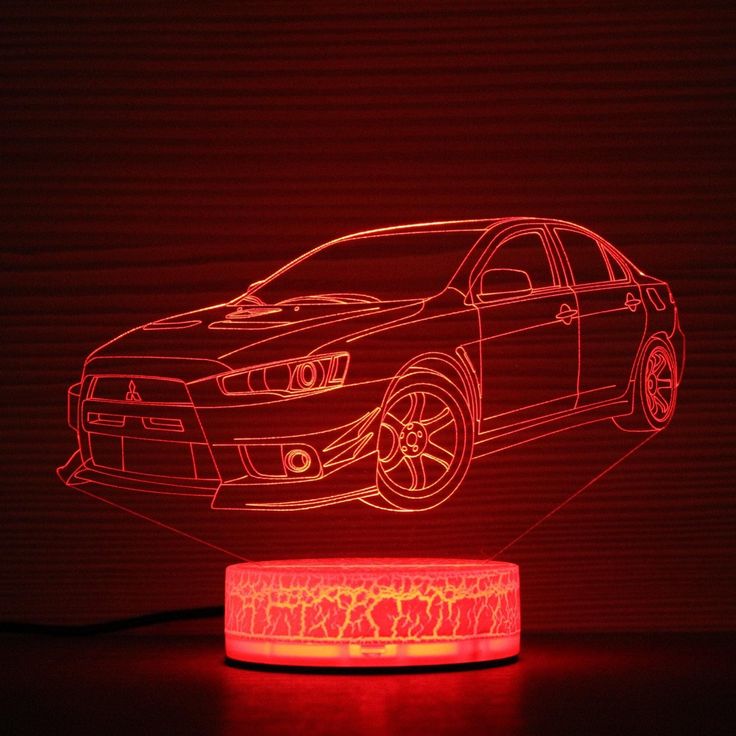 a car is shown in the shape of a lamp with red light coming from it