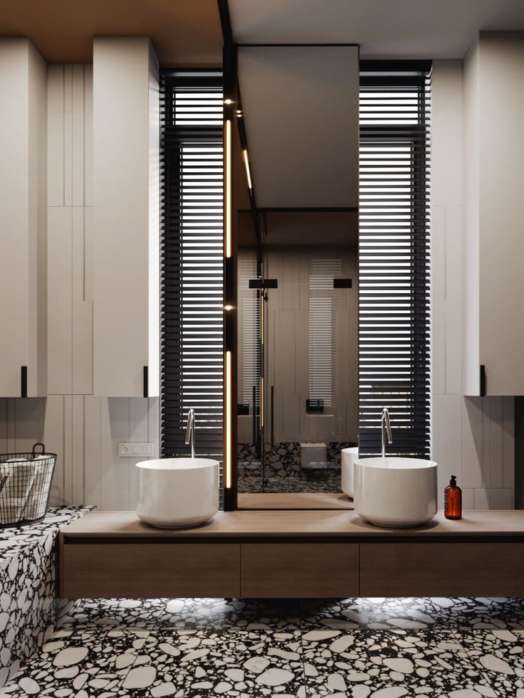 a modern bathroom with two sinks and large mirrors