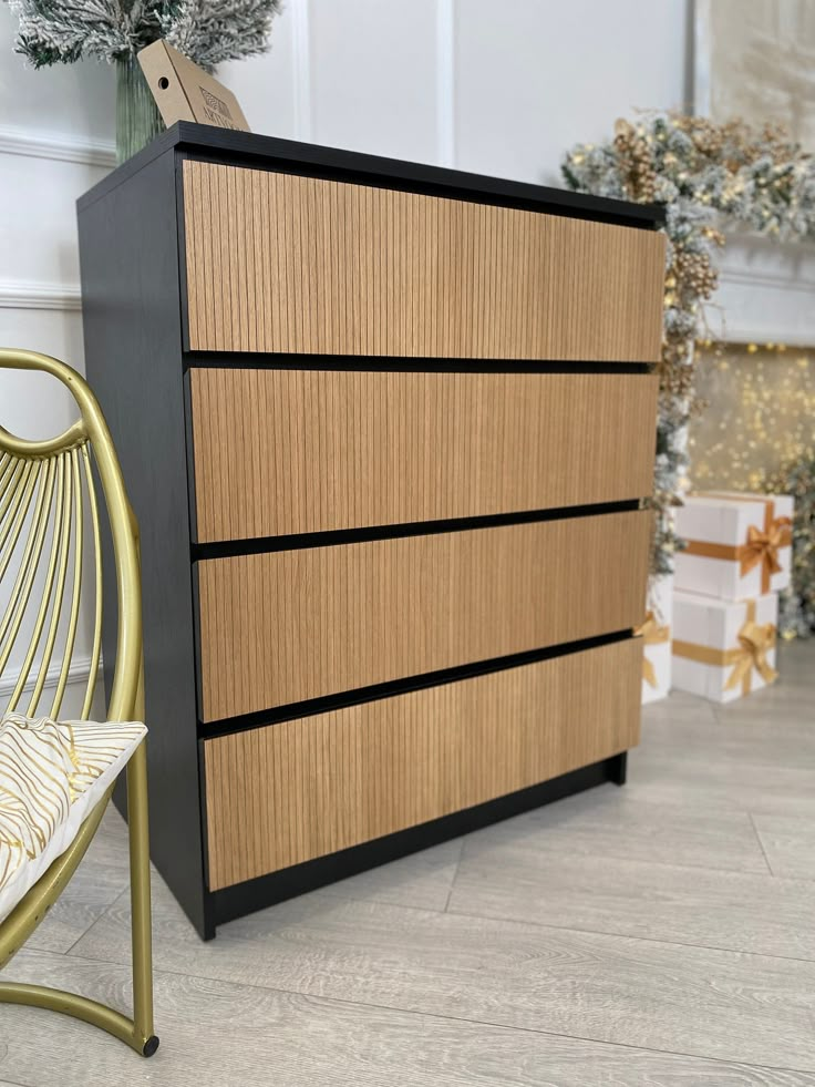 a wooden dresser sitting next to a metal chair