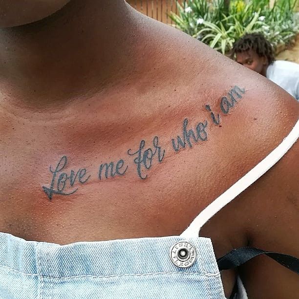 a woman with a tattoo on her chest saying live me for the way