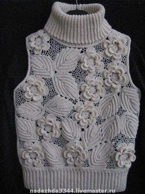 a white knitted sweater with flowers on the front and back, in an applique