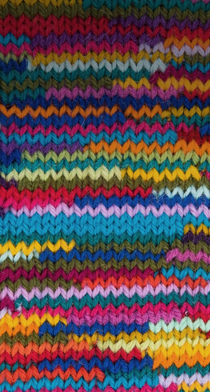 a multicolored knitted blanket with wavy lines