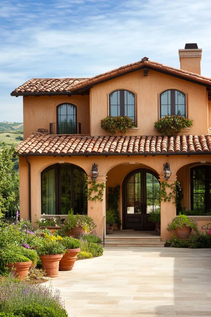 a large house with lots of windows and plants