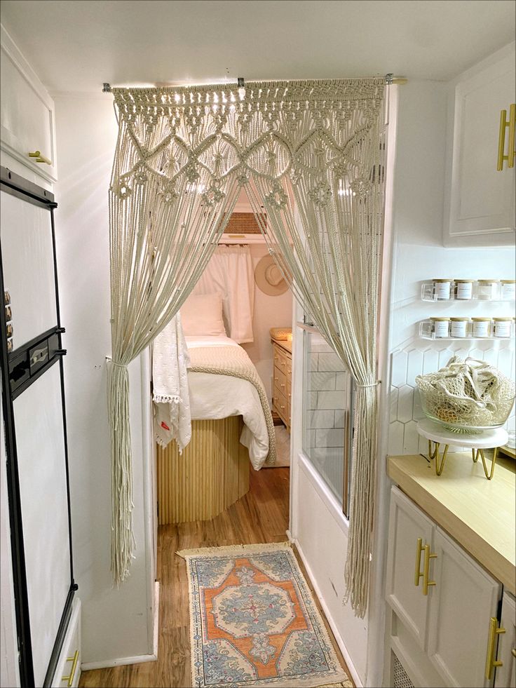 Renovated 1991 RV. White walls, wood floor, porcelain tile shower and kitchen backsplash, wood fluted bed, macrame hanging, linen bedding Hippy Caravan Interior, Boho Camper Ideas, Camper Interior Ideas Boho, 70s Rv Remodel, Modern Boho Camper Interior, Camper Boho Interior, Boho Camper Bathroom, Boho Caravan Interior Bohemian, Vintage Trailer Interior Ideas