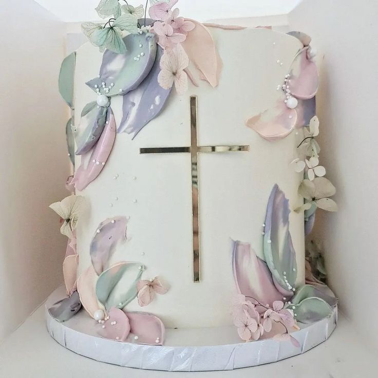 a cake decorated with flowers and a cross