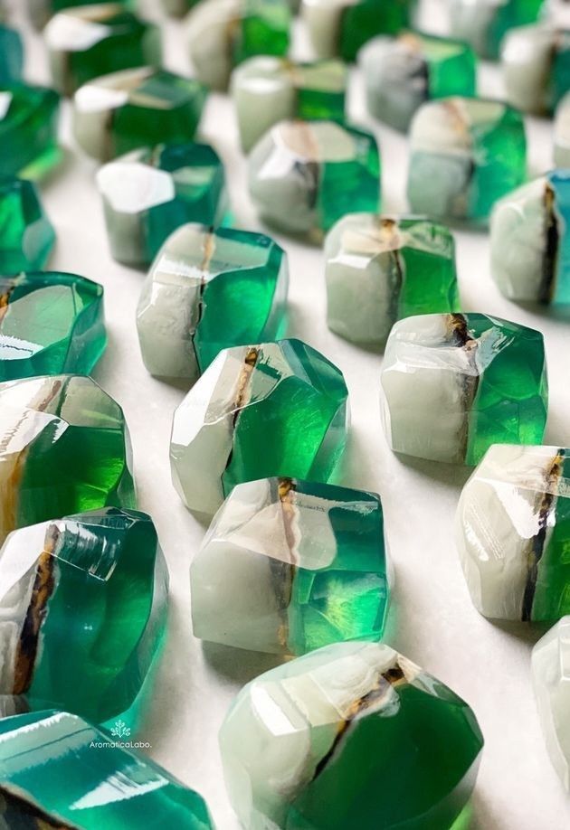 many green and white pieces of glass on a table