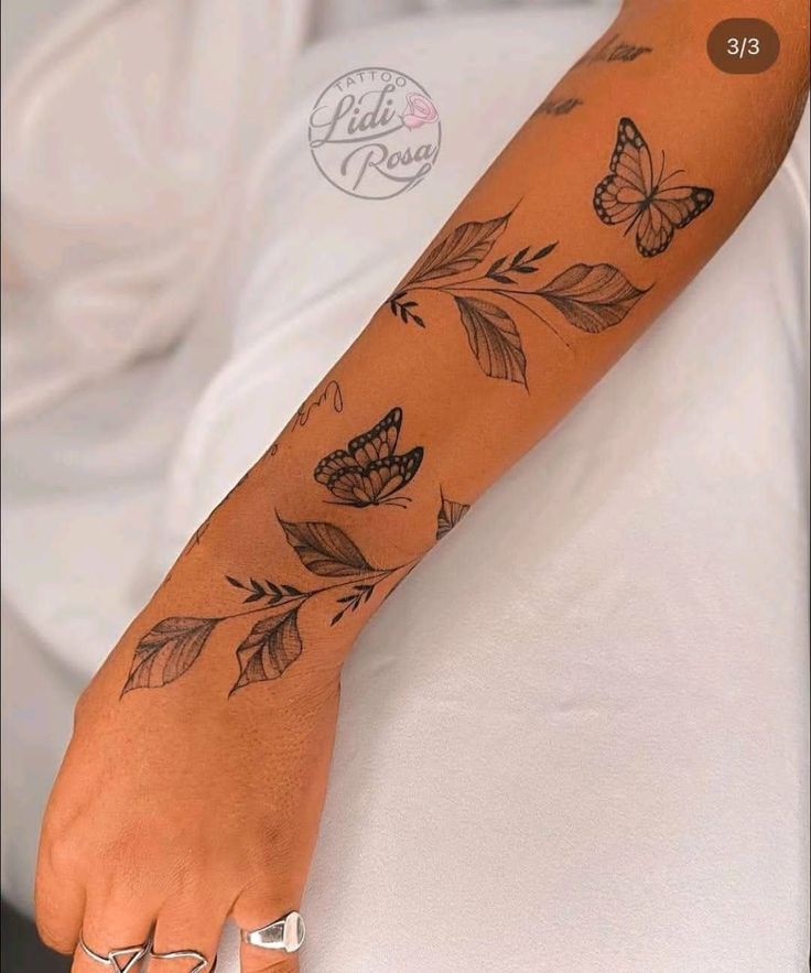 a woman's foot with butterfly tattoos on her left arm and the bottom part of her leg