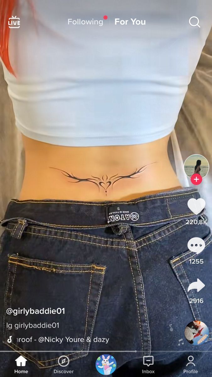 the back of a woman's stomach with tattoos on it