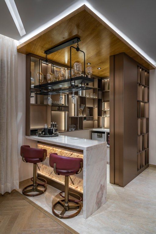 a kitchen with two bar stools next to it