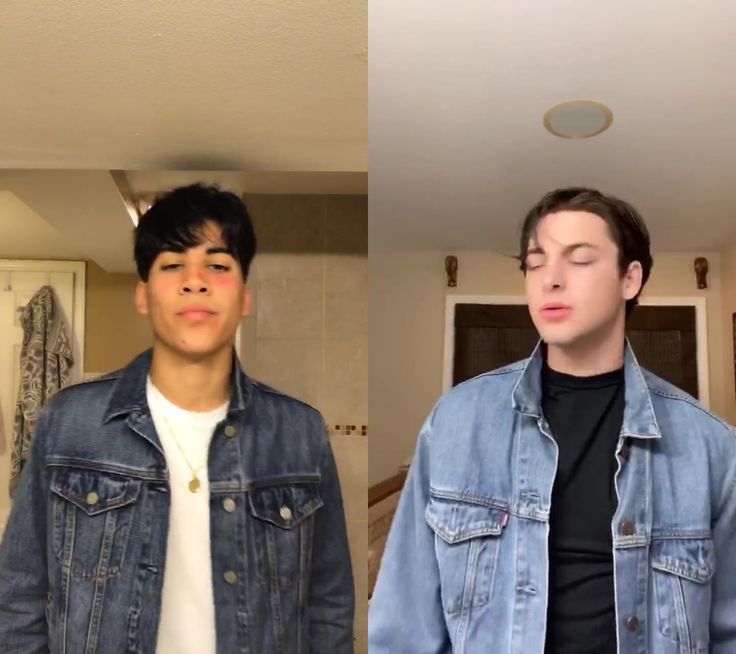 two young men standing next to each other in front of a mirror and one wearing a jean jacket