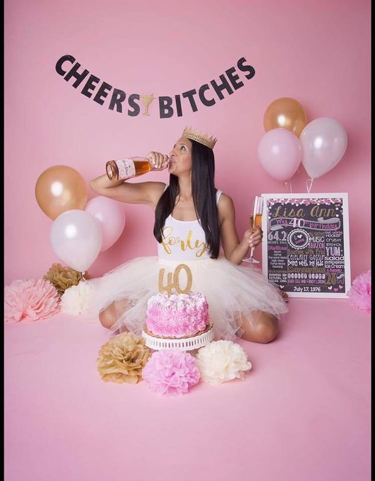 a woman sitting in front of a birthday cake