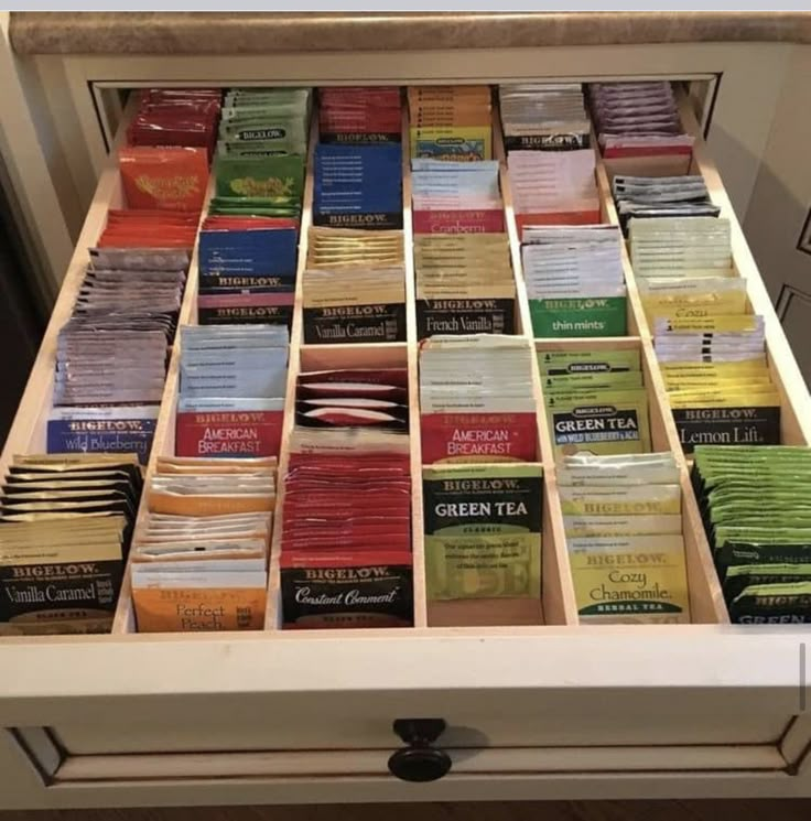 a drawer filled with lots of different types of teas on top of each other