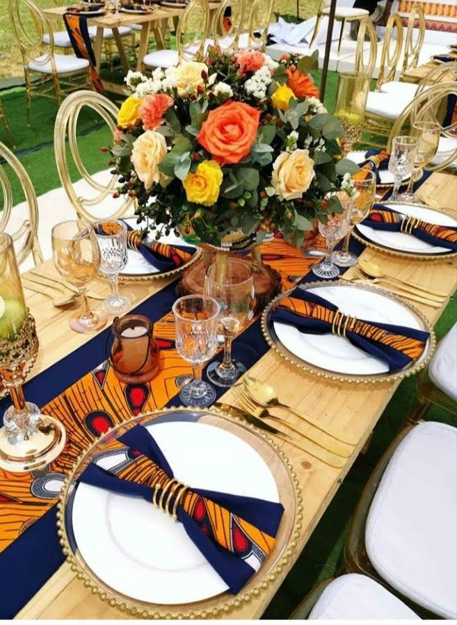 the table is set with place settings and flowers in vases on top of them