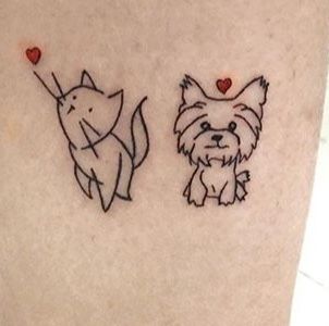 two small dogs with hearts on their ears are drawn on the side of a woman's leg