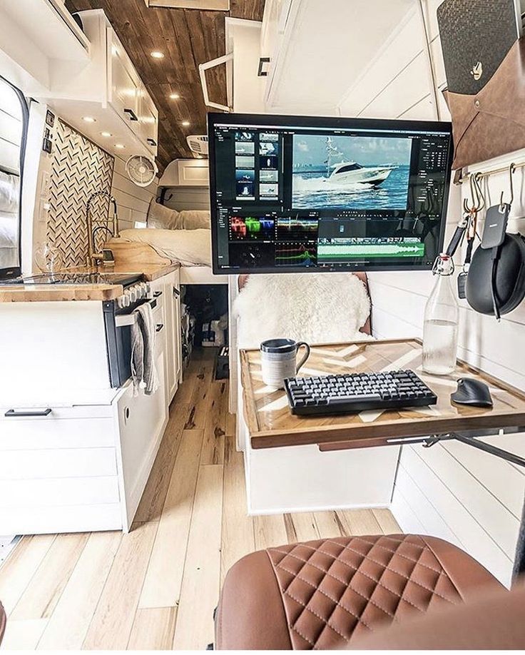 the interior of a camper with a computer and keyboard