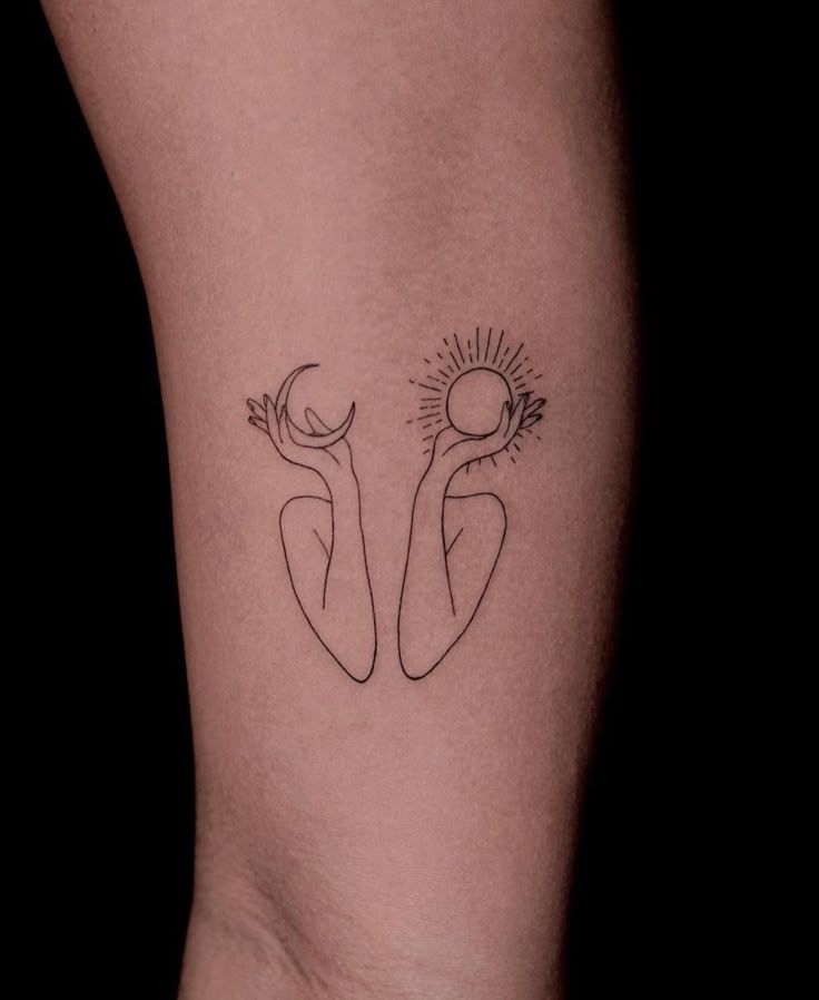 a woman's leg with two tattoos on it