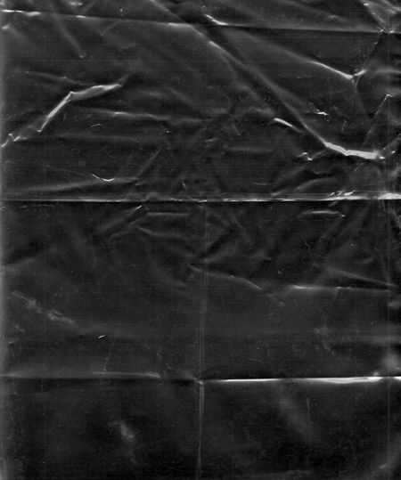 an old black and white photo of a piece of plastic