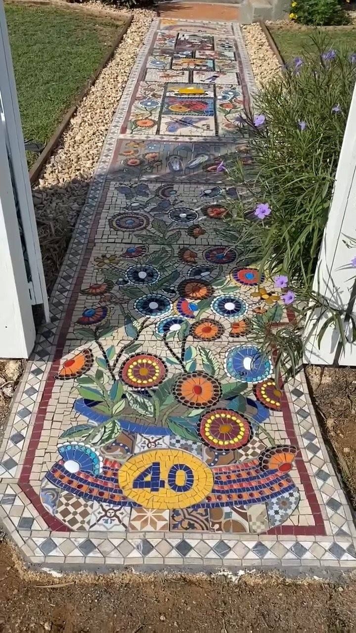 an image of a mosaic walkway with flowers and numbers painted on it, along with the words check out this incredible mosaic see more