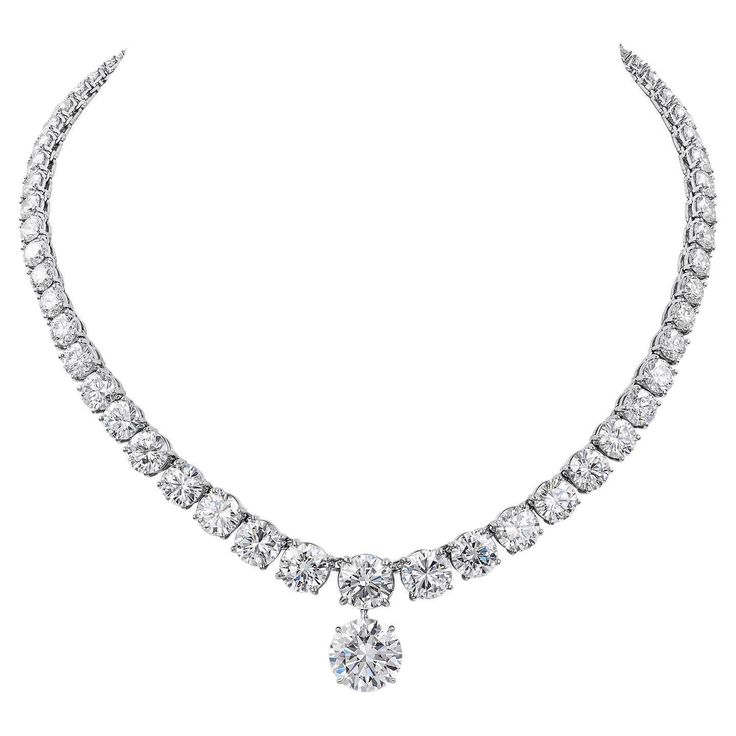 Haute-joaillerie diamond necklace riviera style with a diamond pendant. The necklace is comprising of 67 graduated round-cut diamonds, mounted in platinum. 16 diamonds are GIA certified weighing from 0.73 carats to 3 carats. The colors are from D to F, clarity from IF to SI1. The center diamond in the necklace is 3 carats, F VVS2. A copy of the GIA report is attached to the pictures. Pendant is a 6.54 carat round diamond F VVS1. Certified by GIA. Total weight of diamonds in the necklace is 44.72 carats. Total weight of diamonds including pendant is 51.26 carats. Metal is platinum; gross weight 60 grams. Length of the necklace without the pendant is 15 1/4 inches. The copies of all the GIA reports will be provided upon request. 1stdibs Diamond Necklace, Luxury Gia Certified Collectible Jewelry, Luxury Dazzling Diamond Necklace With Prong Setting, Luxury Fine Jewelry Three Stone Necklace, Luxury Refined Diamond Necklace With Prong Setting, Luxury Platinum Diamond Pendant Necklace, Luxury White Gold Necklace With Gemstone, Luxury Fine Jewelry Necklace With Three Stones, Luxury Platinum Diamond Necklace With Halo Setting