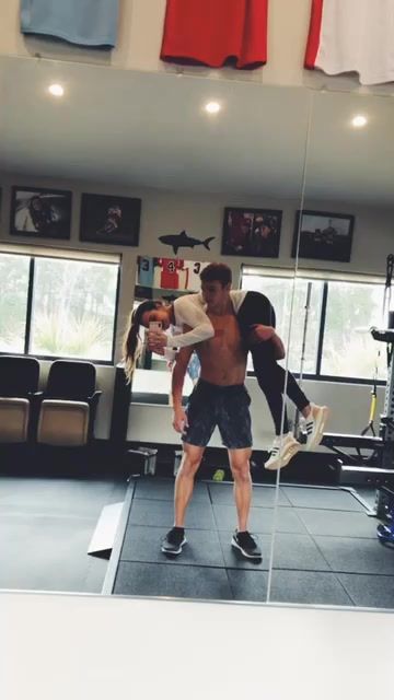 a man and woman doing exercises in a gym