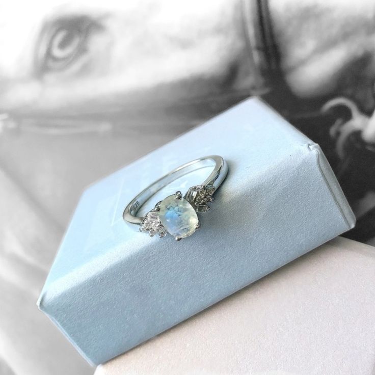 a ring sitting on top of a blue box