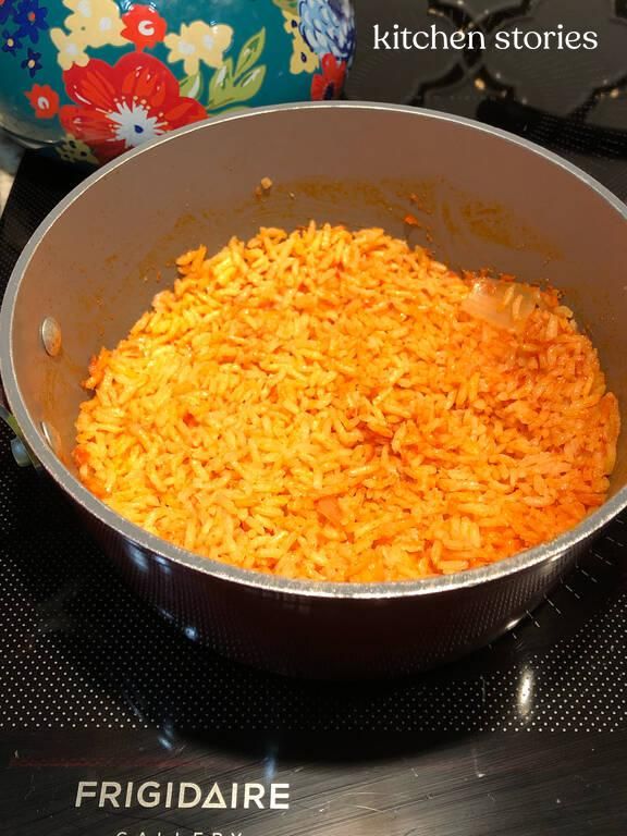 a pan filled with rice sitting on top of a stove