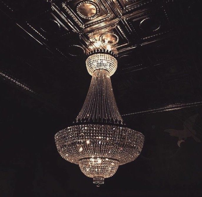 a chandelier hanging from the ceiling in a dark room