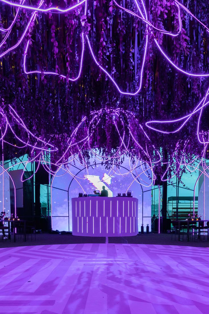 Birthday party lights up in purple turning this neon dreamy forest into a magical place Dark Purple Party Aesthetic, Dreamy Decor Party, Galaxy Event Decor, Neon Jungle Party, Galaxy Party Decorations, Neon Forest, Neon Party Decorations, Lila Party, Dreamy Forest