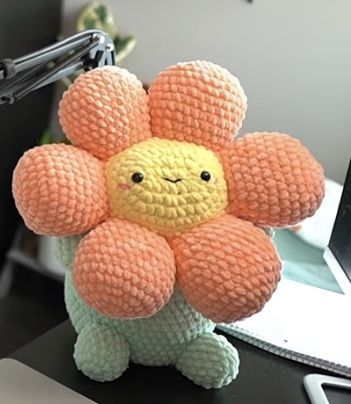 a stuffed flower sitting on top of a desk