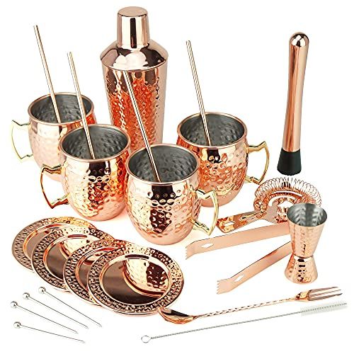 a set of copper colored cocktailware including cups, spoons and utensils