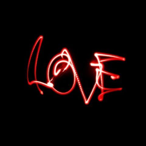 the word love written in red neon lights