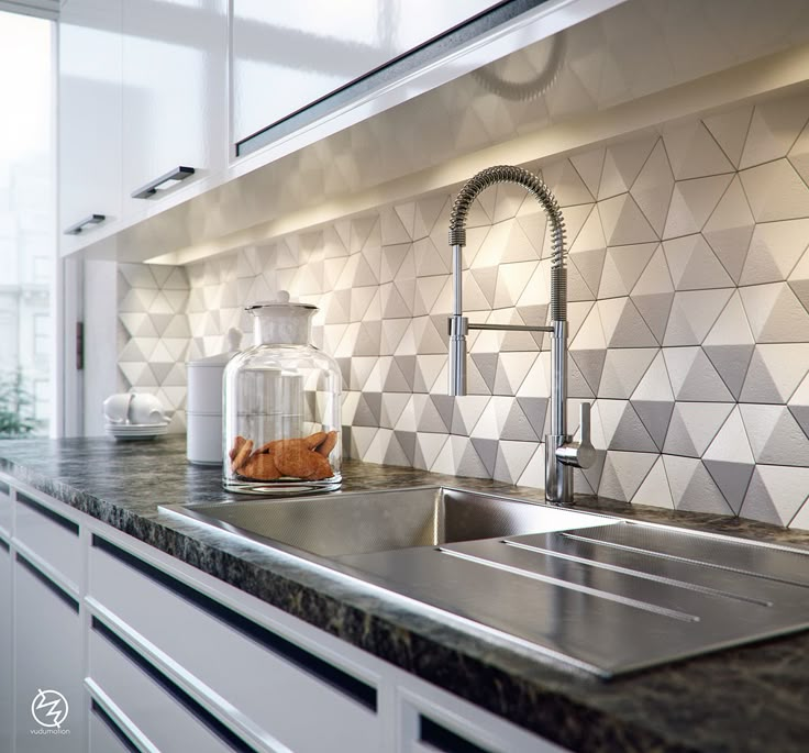 a kitchen counter with a sink, faucet and tiled backsplash